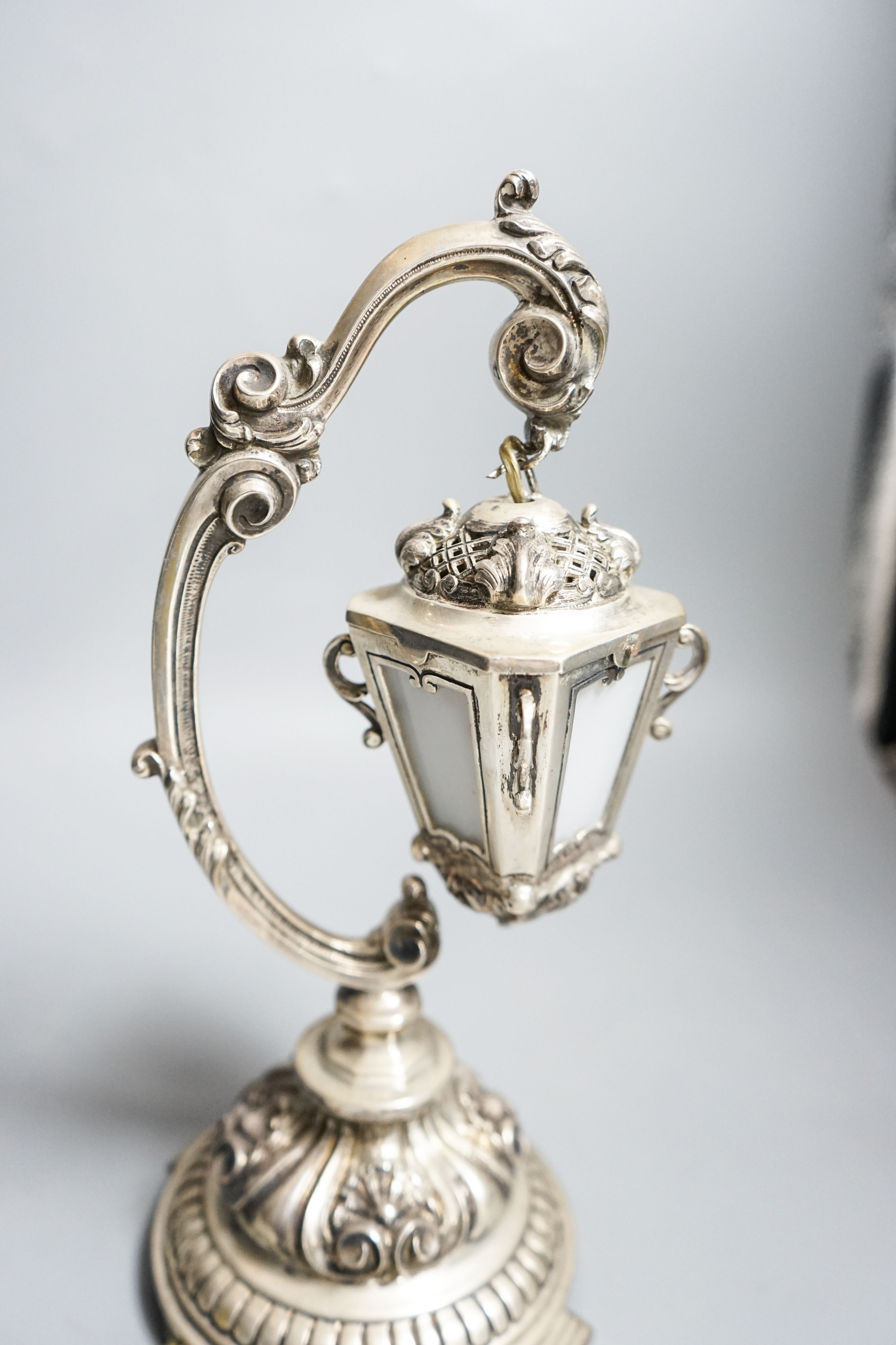 A Portuguese white metal table lamp modelled as a hanging lantern, height 28.1cm.